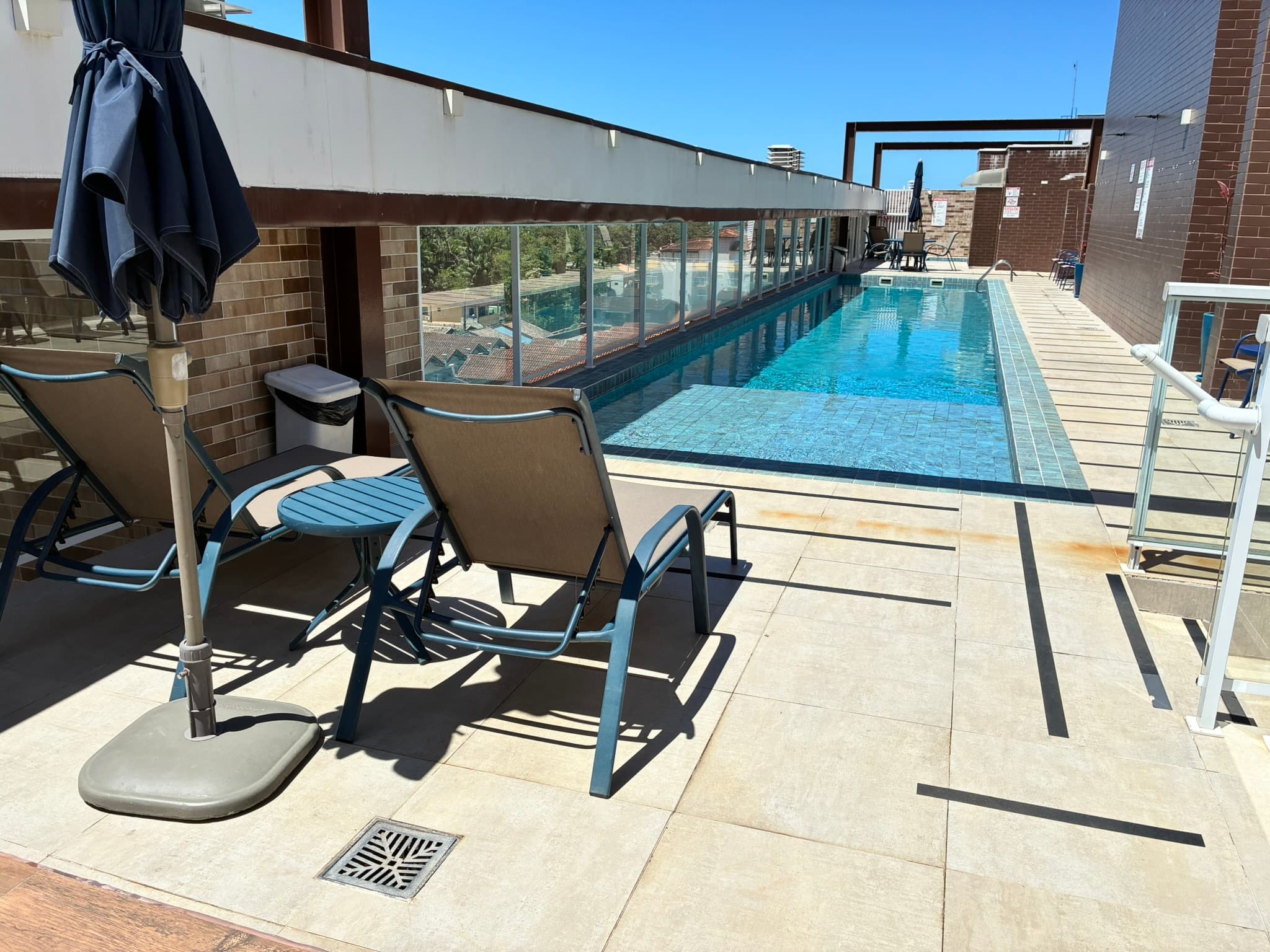 Piscina do condomínio com espreguiçadeiras